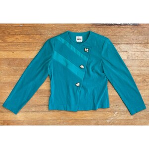 May include: Teal blazer with a diagonal seam and silver buttons. The label reads "M.M. LaFleur".