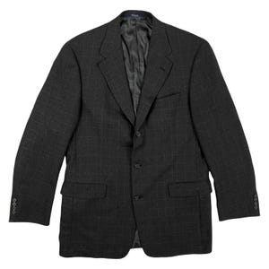 May include: A dark gray plaid blazer with a notched lapel and three button closure.