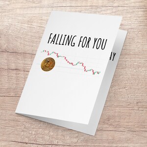 May include: A white card with the text "Falling for you" and a downward trending line graph with a gold Bitcoin coin at the top of the graph.
