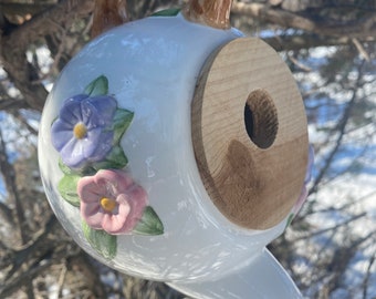 Spring flowers adorn this bird home.