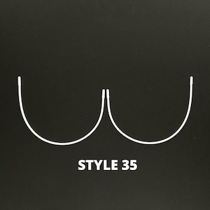 May include: White wire bra underwire style 35 on a black background.