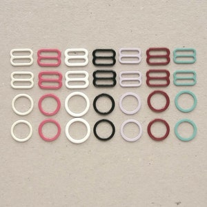 Colored bra making rings and sliders. Nylon and enamel coated metal lingerie strap adjusters. 11-12 mm (1/2 in)