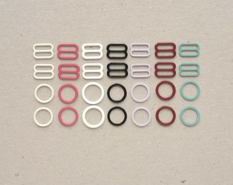 Farbige BH-Ringe und Schieber. Nylon und emaillierte metallfarbene Dessous-Träger-Versteller. 11-12 Millimeter