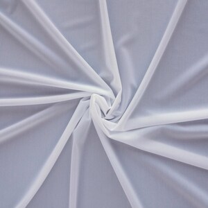 May include: White sheer fabric with a soft, flowing texture. The fabric is gathered in the center, creating a swirling pattern.