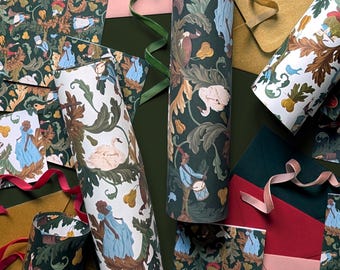 May include: Wrapping paper rolls and flat sheets featuring a repeating pattern of figures in blue and red clothing, white swans, and pears amidst dark green foliage. The set includes various coloured envelopes in red, pink, and gold, with green ribbons.
