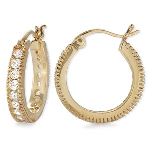 May include: Gold hoop earrings with a row of clear cubic zirconia stones around the edge.