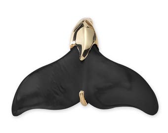 May include: Black and gold whale tail pendant charm. The tail is made of black onyx and the top is gold.