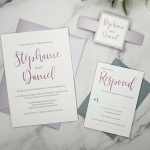 May include: Wedding invitation with a white background and purple text. The invitation reads "Stephanie and Daniel" and includes the date, time, and location of the wedding. The RSVP card is blue with white text and includes the date to respond by.