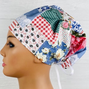 May include: A blue, red, green, and white patchwork scrub hat with a white tie. The hat has a variety of floral patterns.