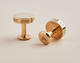 May include: A pair of gold cufflinks. One cufflink is engraved with the text "Happy 21st Birthday Son 09.07.1991". The other cufflink is engraved with the text "Robert John Baker".