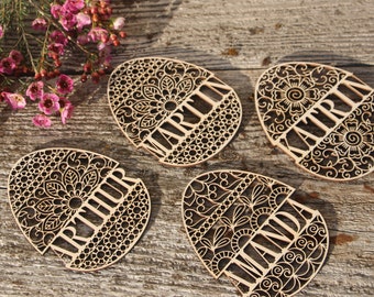 May include: Four wooden Easter eggs with intricate laser-cut designs and personalized names: "Martin", "Kayla", "Arthur", and "Miranda".