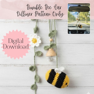 May include: A crochet car air freshener pattern featuring a bumble bee design. The bee is yellow and black with white wings. The pattern includes a daisy, leaves, and a diffuser. The text reads "Bumble Bee Car Diffuser Pattern Only" and "Digital Download".