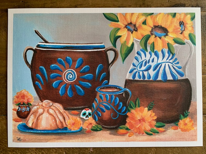 May include: A still life painting featuring a brown clay pot with blue and white floral designs, a smaller brown clay mug with blue and white floral designs, a light brown pan dulce, and a bouquet of yellow sunflowers in a brown clay pitcher with blue and white floral designs.