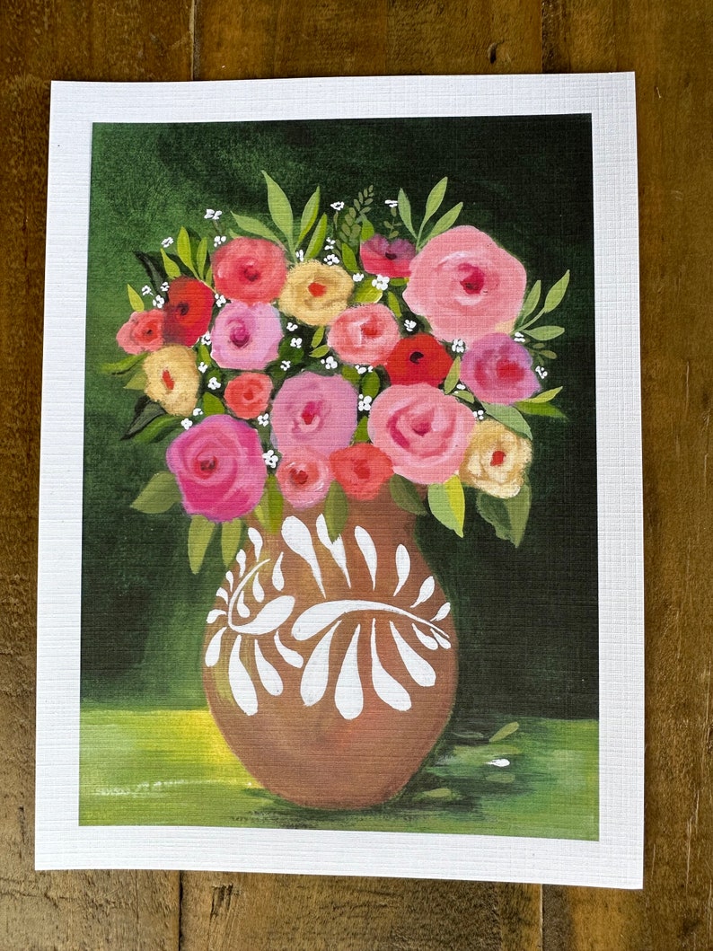May include: A floral painting featuring a brown vase with white decorative accents, filled with a bouquet of pink, red, and yellow roses and greenery. The background is a dark green, with a light green area at the bottom.
