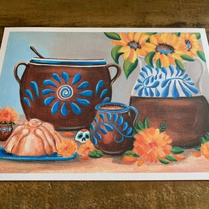 May include: A painting of a still life featuring a brown clay pot with blue floral designs, a smaller brown clay pot with blue leaf designs, a light brown pan with a light brown pastry, and a bouquet of yellow sunflowers in a brown clay pot with blue floral designs.
