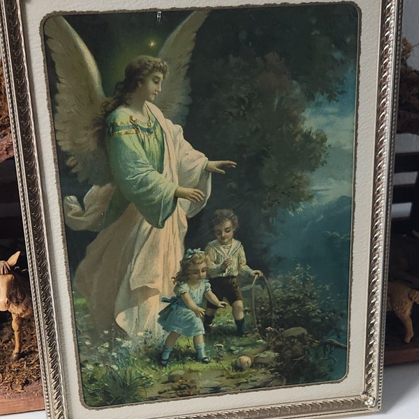 Vintage guardian angel picture...framed in gold metal...on a cliff