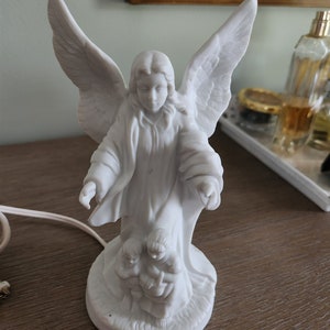 Guardian angel night light....white....porcelain bisque...good condition