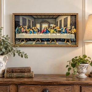 May include: A rectangular wall art print depicting The Last Supper, featuring a central figure in red and blue robes seated at a long table with twelve figures in various colored garments, all enclosed in a decorative gold-toned frame.