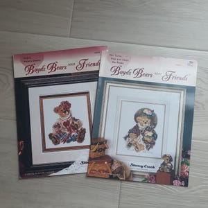 May include: Two Boyd's Bears and Friends cross-stitch pattern books. One features a bear with a heart, the other a bear with a hat and flowers. The text includes "Balire Heart's Desire" and "Mrs. Tuttle... Stop and Smell the Roses."