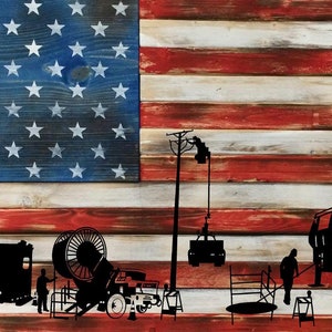 May include: Silhouettes of utility workers and trucks against a red, white, and blue American flag background. The workers are using equipment to install or repair power lines.