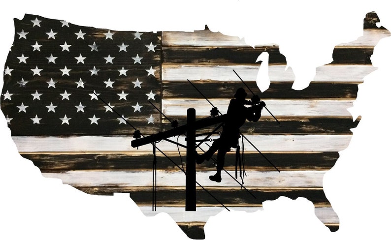 May include: A silhouette of a worker on a power line pole is superimposed on a distressed wood American flag in the shape of the United States.
