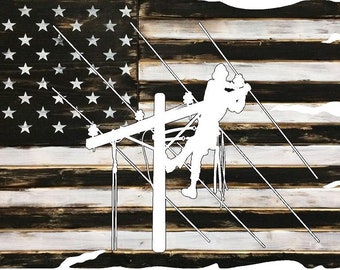 May include: A white silhouette of a worker on a power line pole against a distressed black and white American flag background.