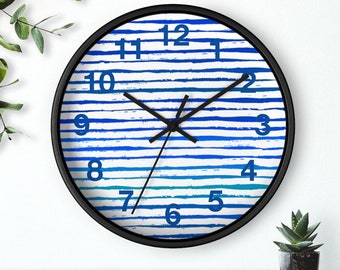 May include: A black and white striped clock with blue stripes. The clock face has black hands and blue numbers.