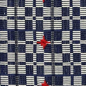 May include: Close-up of a woven textile with a geometric pattern. The design features a grid of dark blue squares and white horizontal stripes. Three red star-shaped embroidered accents are evenly spaced across the fabric.