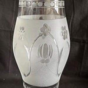 May include: A frosted glass lampshade with an etched floral design. The shade has a clear glass base and a white frosted top.