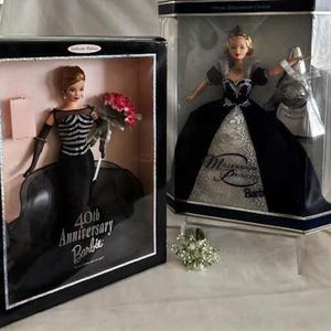 May include: Two Barbie collector edition dolls in their original boxes. One is the 40th Anniversary Barbie, wearing a black gown and holding flowers. The other is the Millennium Princess Barbie, in a blue and silver gown.