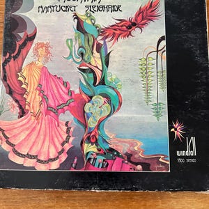 May include: Vintage vinyl record album cover for the band Mountain, titled "Nantucket Sleighride." The cover art features a colorful, psychedelic illustration with figures and abstract shapes in shades of pink, blue, green, and red. The album is labeled "Windfall 5500 Stereo."
