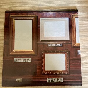 May include: A vintage vinyl record album cover featuring four framed paintings. The paintings are titled "The Great Gates of Kiev", "Promenade", "The Curse of Baba Yaga", and "Of".