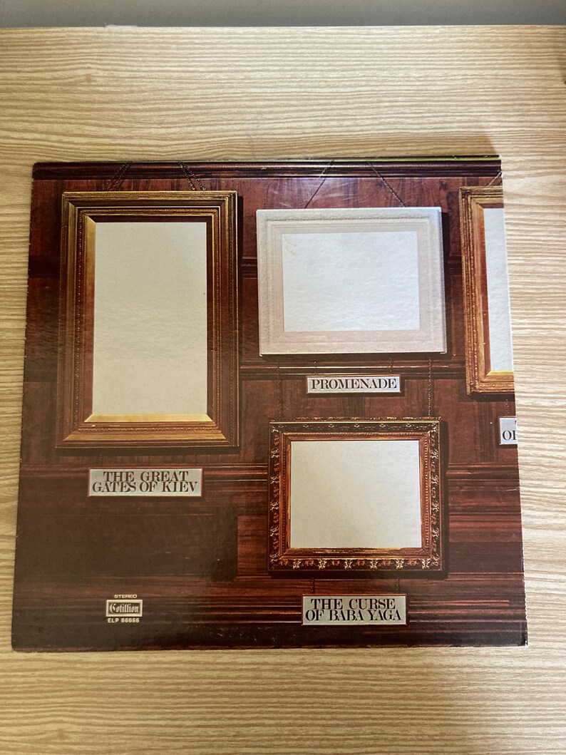 May include: A vintage vinyl record album cover featuring four framed paintings. The paintings are titled "The Great Gates of Kiev", "Promenade", "The Curse of Baba Yaga", and "Of".