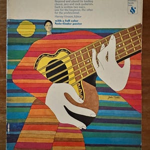 May include: The cover of "The Complete Guitar Scale Manual" features a colorful illustration of a guitar and hands playing it. The title is in green, with text describing the book's content. The cover also includes the author's name and a note-finder poster.