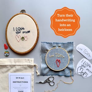 May include: An embroidery kit with the text "I Love You Mom" and a heart design. The kit includes a wooden hoop, fabric, thread, and instructions. The image also features a denim embroidery with the text "Love TOM" and a heart, plus the text "Turn their handwriting into an heirloom."