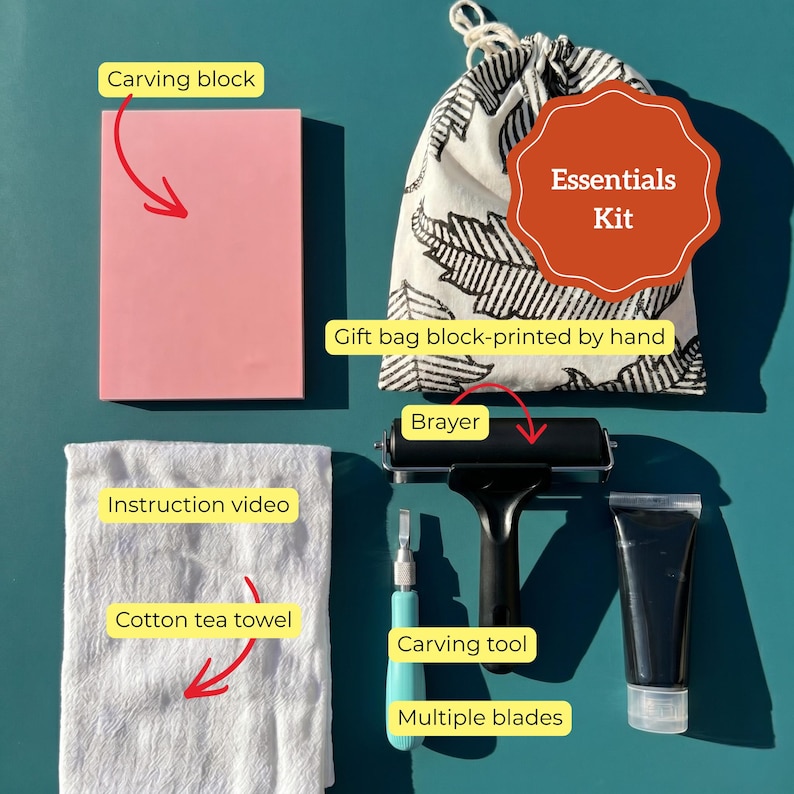 May include: An essentials kit for printmaking, featuring a pink carving block, a black brayer, a carving tool, multiple blades, and a tube of black ink. Includes a cotton tea towel, instruction video, and a block-printed gift bag.