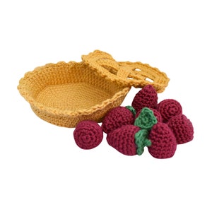 Puede incluir: Una costra de pastel de crochet amarillo con una tapa de crochet, llena de fresas rojas de crochet.