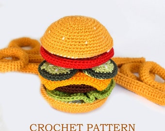 May include: Crocheted amigurumi burger with a yellow bun, red tomato, green lettuce, and brown meat patty. The burger is accompanied by a crocheted order of french fries.