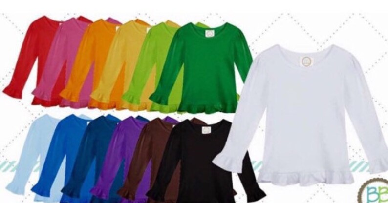 May include: A collection of long-sleeved shirts in various colors, including red, pink, orange, yellow, green, blue, purple, brown, black, and white. Each shirt has a ruffled hem and cuffs. The shirts are displayed on a white background.
