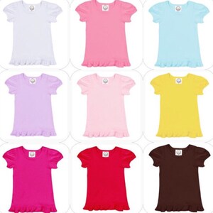 May include: Nine short-sleeved t-shirts in various colors, including white, pink, light blue, lavender, yellow, fuchsia, red, and brown. Each shirt has a ruffled hem and puff sleeves. A small logo is visible on the upper chest of each shirt.