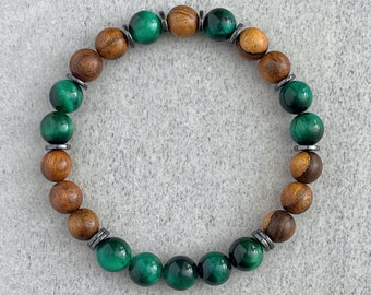 May include: A green and brown beaded bracelet with wooden and tiger's eye beads.