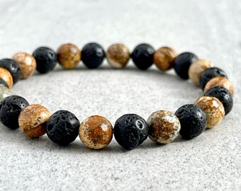 May include: A bracelet made of brown and black beads. The beads are round and have a smooth texture.