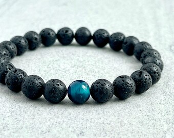 May include: A black lava rock beaded bracelet with a single blue tiger's eye bead.