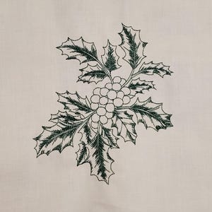 May include: An embroidered design of holly with green leaves and berries on a cream-colored background. The detailed stitching creates a textured effect, perfect for holiday-themed crafts or decor.