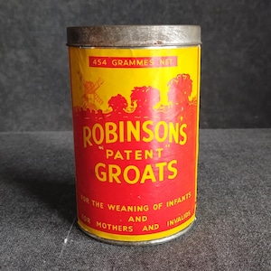 May include: A vintage cylindrical tin of Robinson's Patent Groats. The tin has a yellow background with red text and a silver lid. The text includes "454 Grammes Net" and "For the weaning of infants and for mothers and invalids."