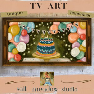 May include: A framed painting of a birthday cake with candles and balloons. The cake is blue and green with white frosting and the balloons are various colors. The painting is in a gold frame and has the text "Happy Birthday" on it.