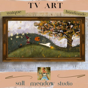 May include: A hand-painted illustration of a pumpkin, a ghost, and a witch in a forest setting. The artwork is framed in a gold frame and features a fall theme with autumn leaves and a tree with lights. The artwork is titled "TV Art" and is signed by the artist.