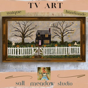 May include: A hand-painted artwork depicting a black house with a white picket fence and two trees. The house has a pink door and yellow windows. There are two ghosts and pumpkins in the yard. The artwork is framed in gold and has the text "TV ART" and "salt meadow studio" on it.