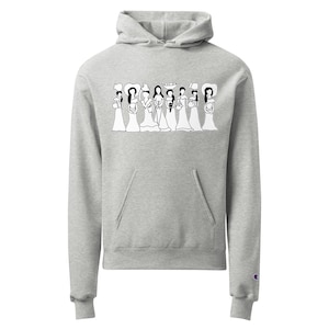 May include: A light gray hoodie with a front pocket and a hood. The front of the hoodie features a black and white graphic of several figures in dresses and hats. The hoodie has long sleeves and a Champion logo on the left sleeve.