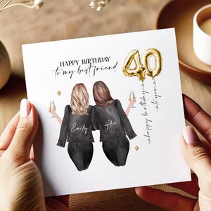 May include: A white card with a gold balloon number 40 and the text "Happy Birthday to my best friend" with two women in black jackets and the names "Emily" and "Alex" on their backs. The text "Happy birthday to you" is written on the right side of the card.
